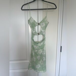 Floral gauze material mini dress with front cut outs and open back. New with tag